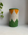 Display of orange, green and white geometric colored vase