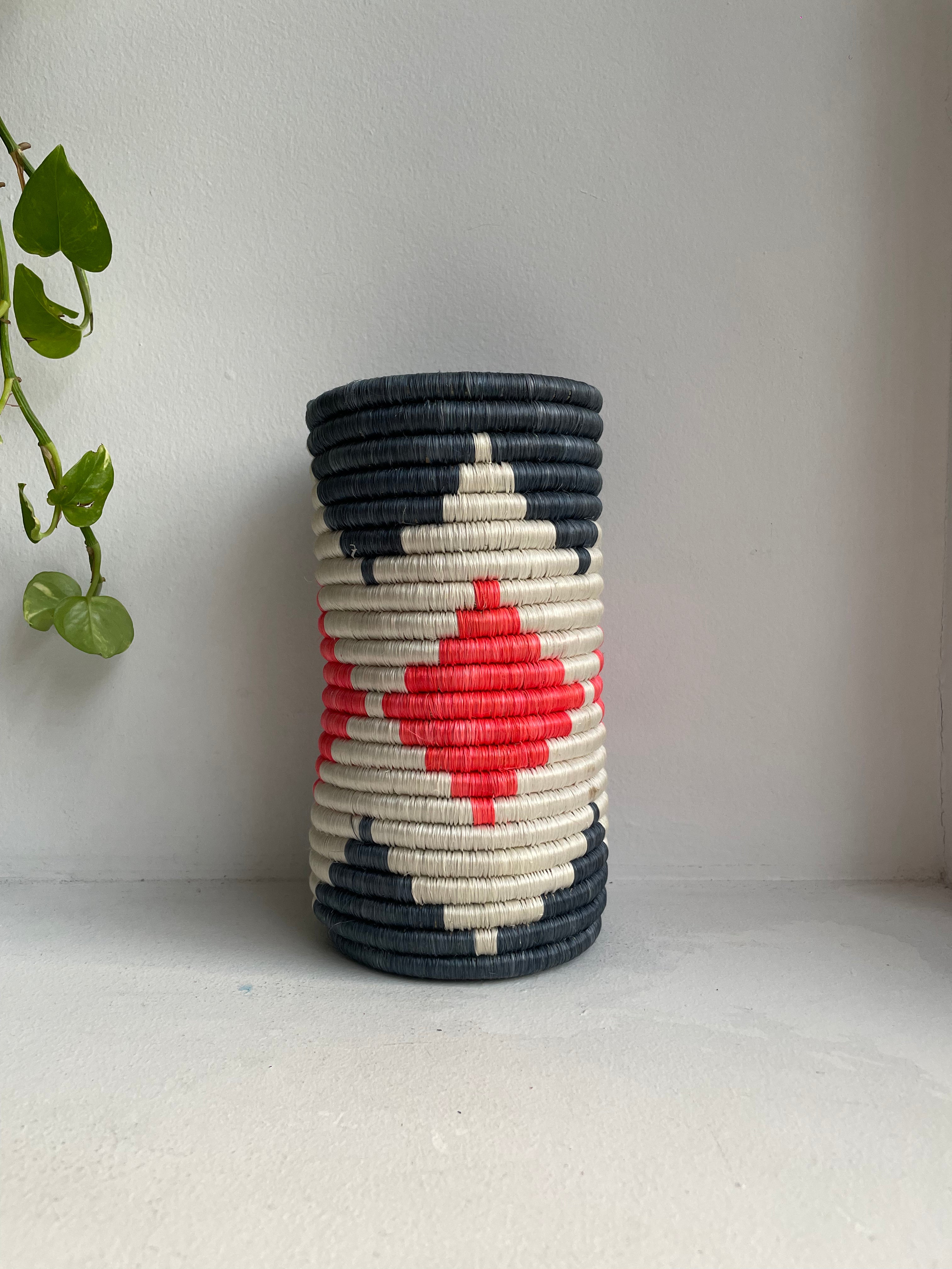 Display of hot pink, white and charcoal colored vase
