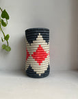 Display of hot pink, white and charcoal colored vase