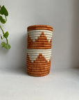 Display of orange and white triangle vase