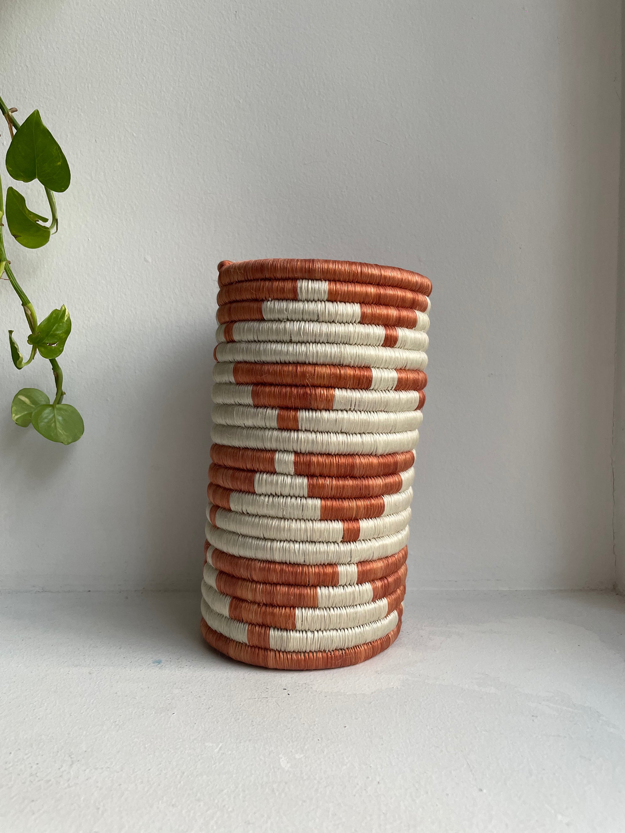 Display of orange and white triangle vase