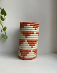 Display of orange and white triangle vase