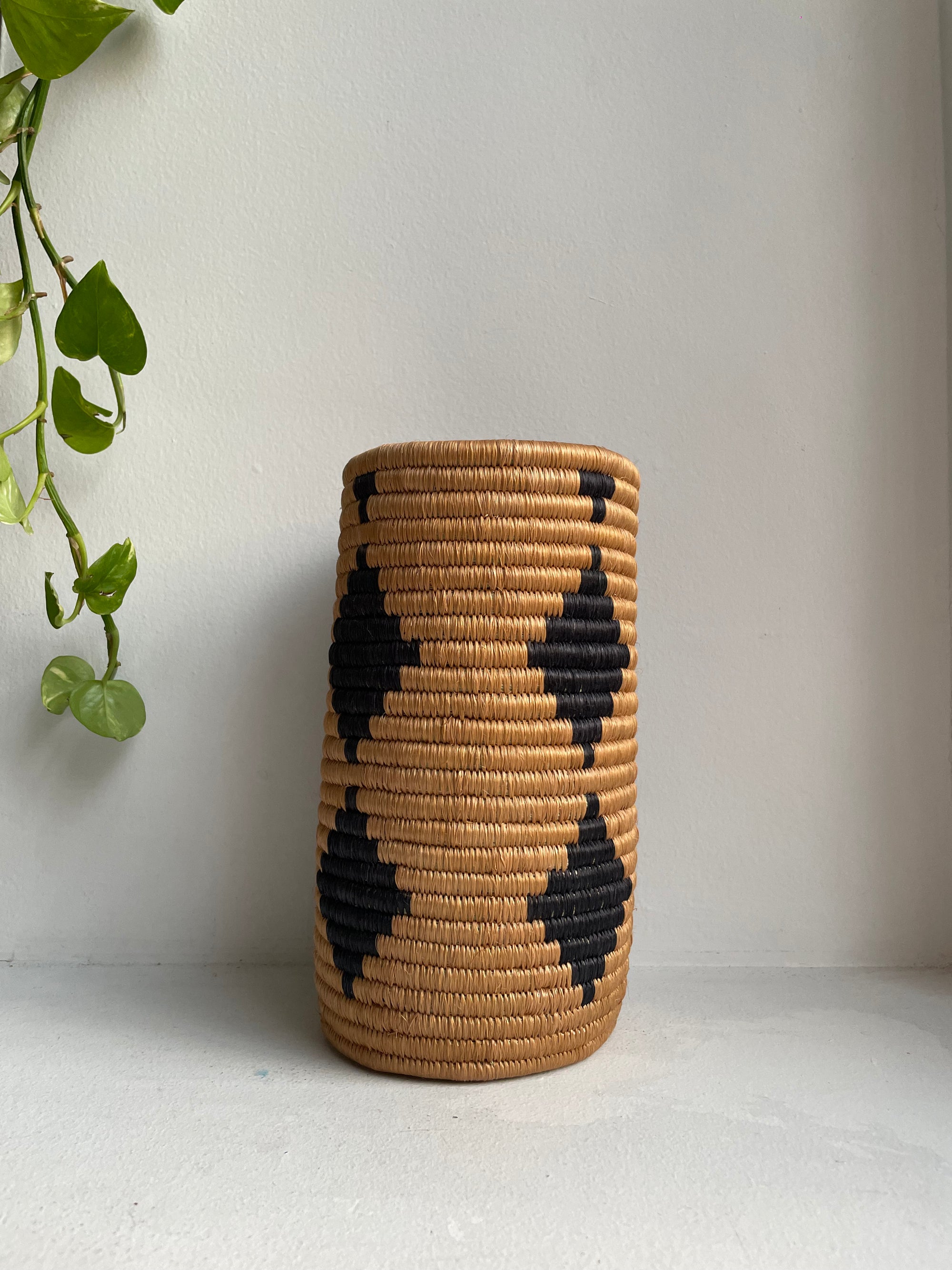 Display of beige and black diamond  vase