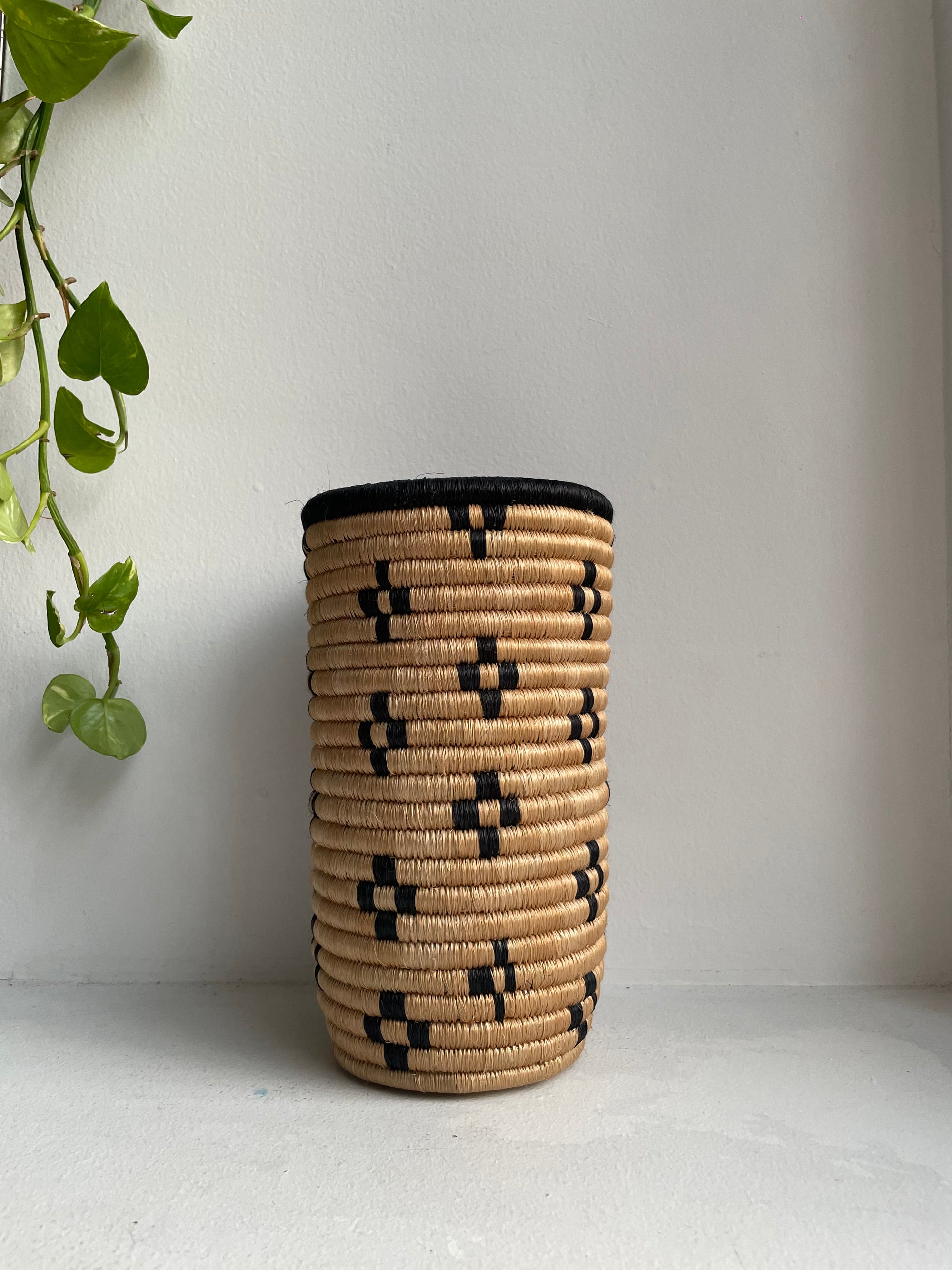 Display of beige vase with black flowers
