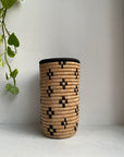 Display of beige vase with black flowers