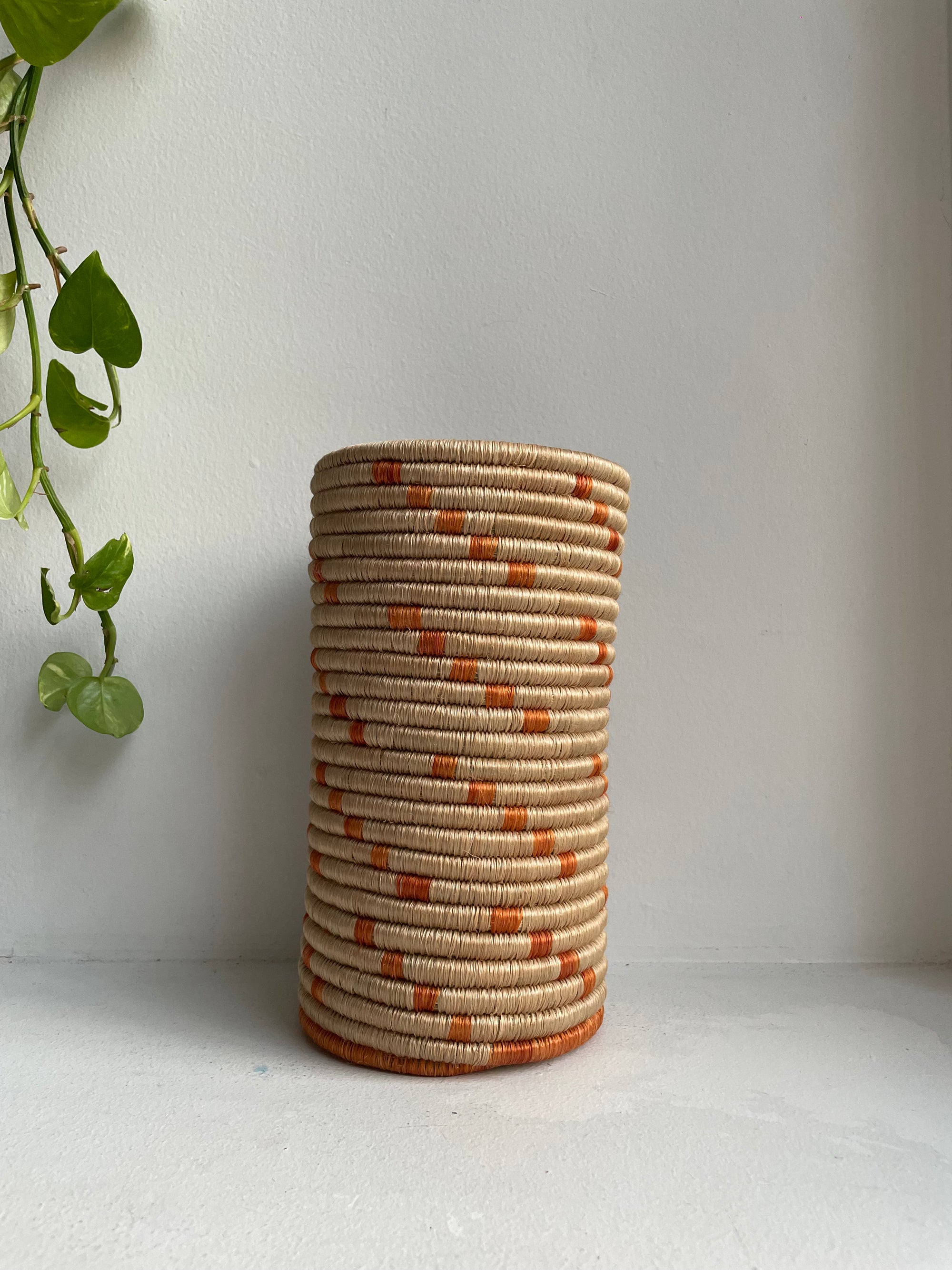 Display of beige and orange colored vase