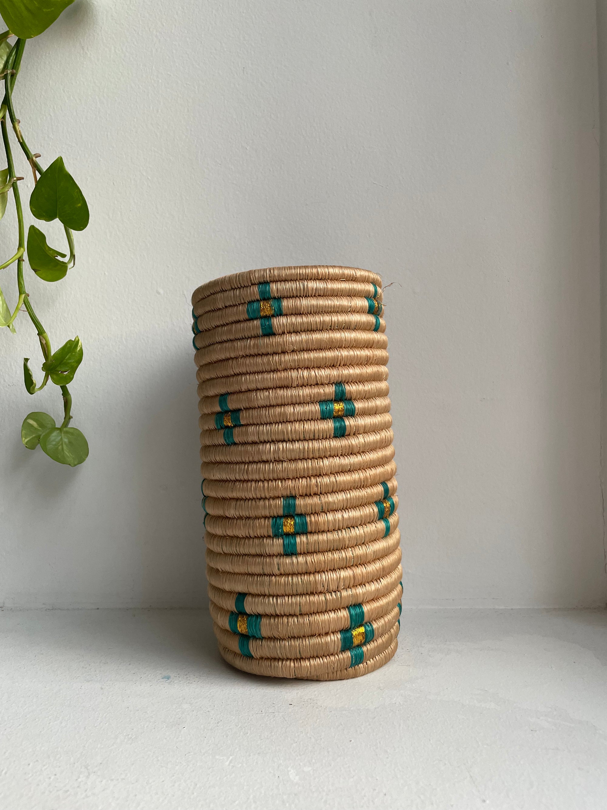 Display of  beige vase with teal and gold flowers