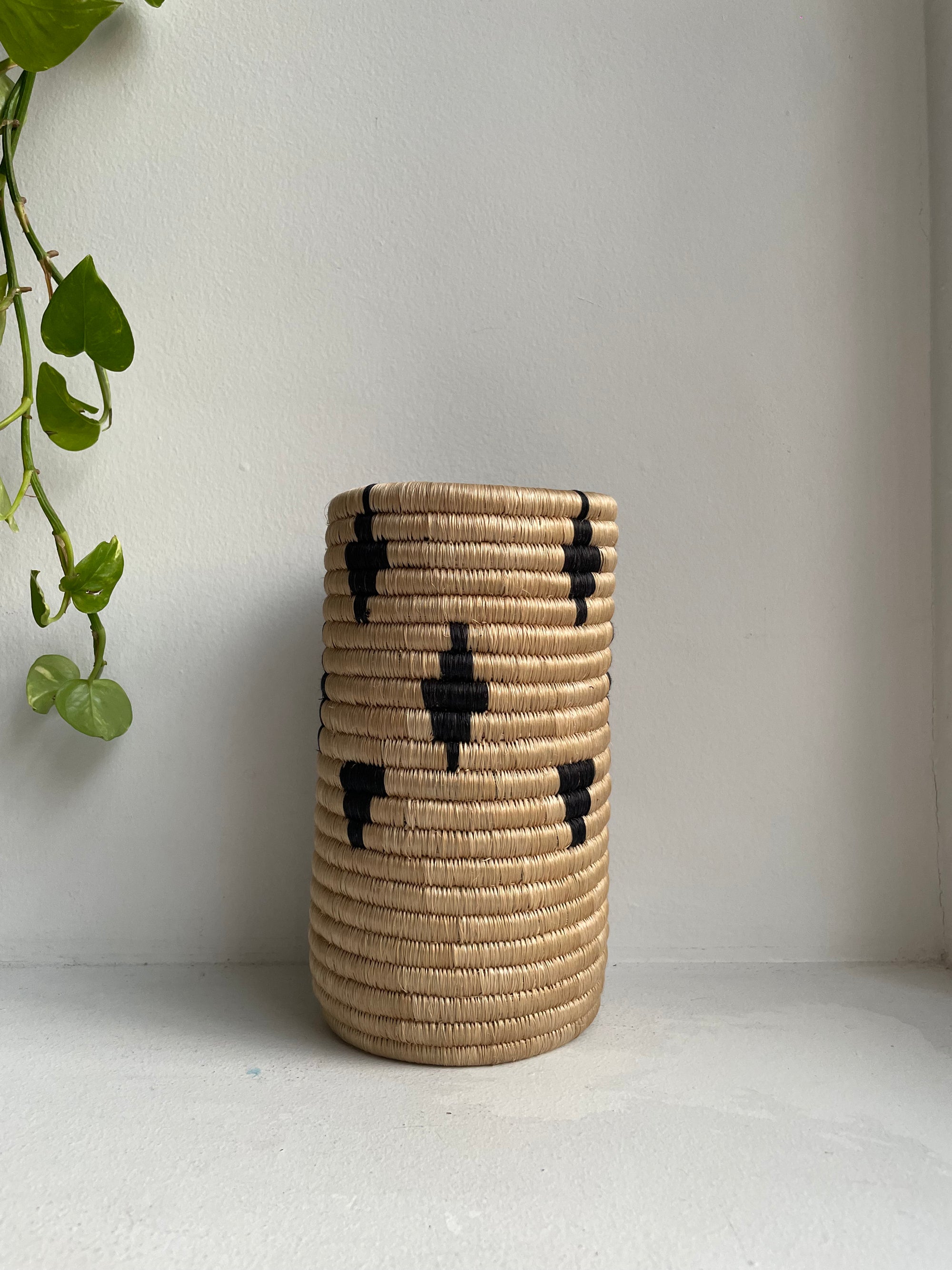 Display of beige vase with black diamonds and triangles