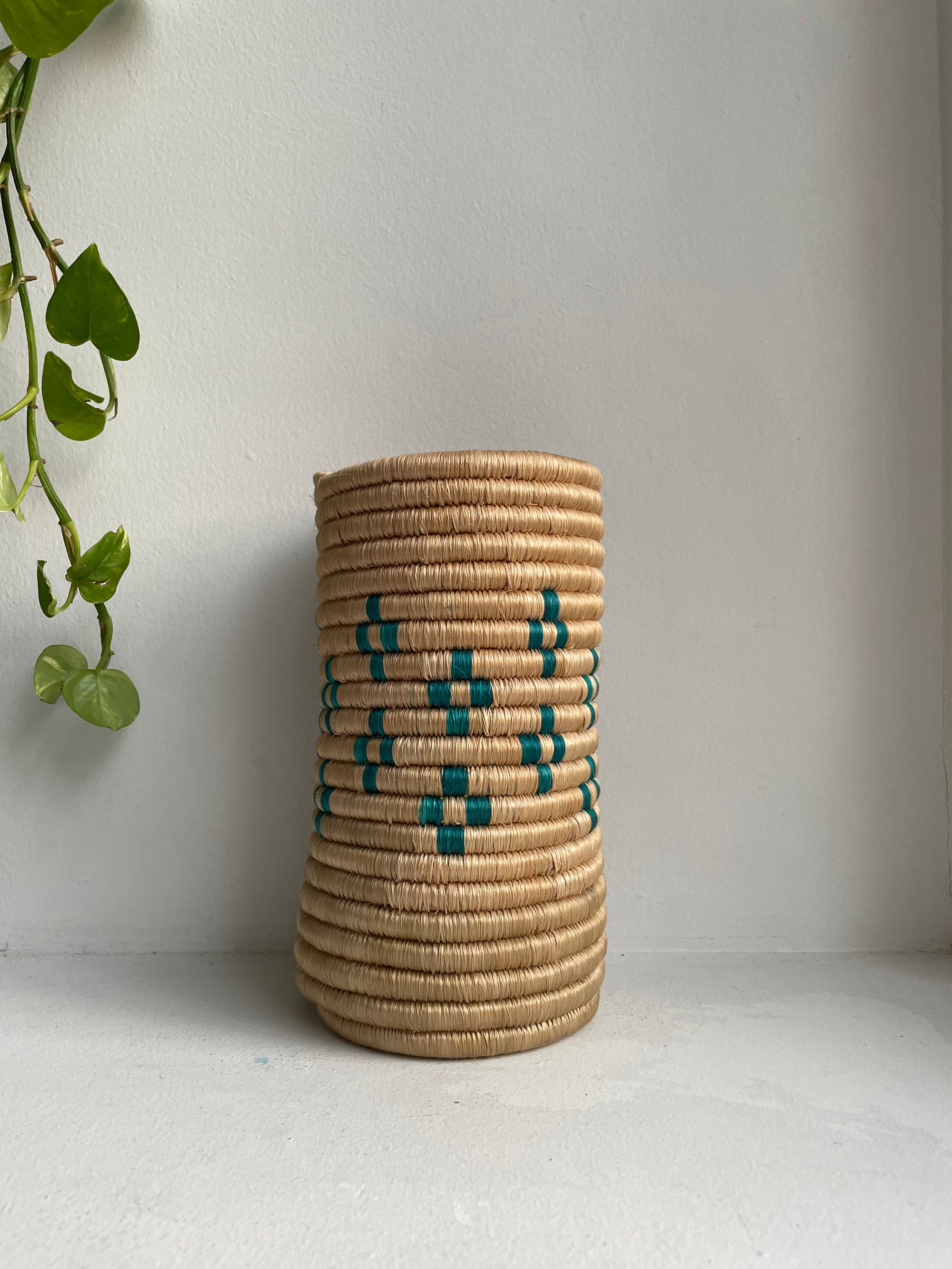 Display of beige and teal colored vase