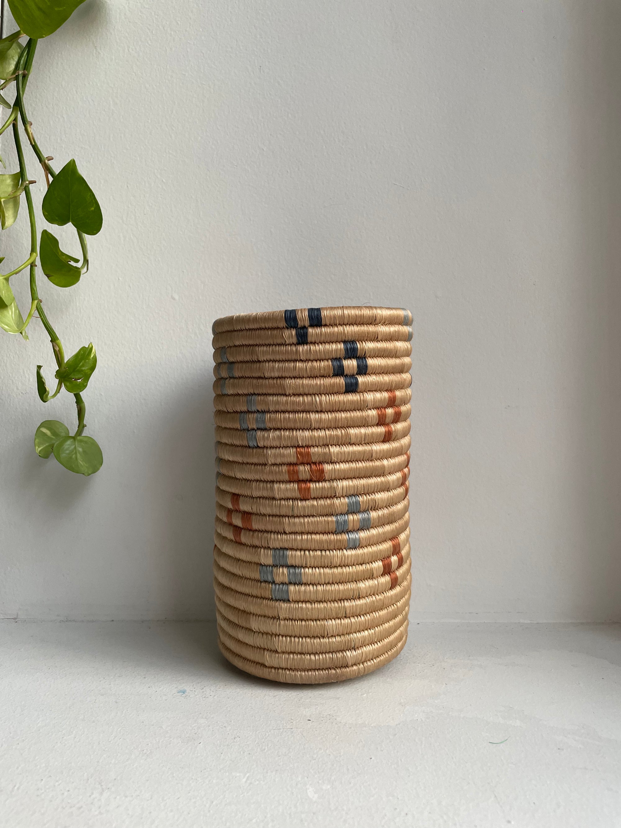 Display of beige colored vase multicolored floral design