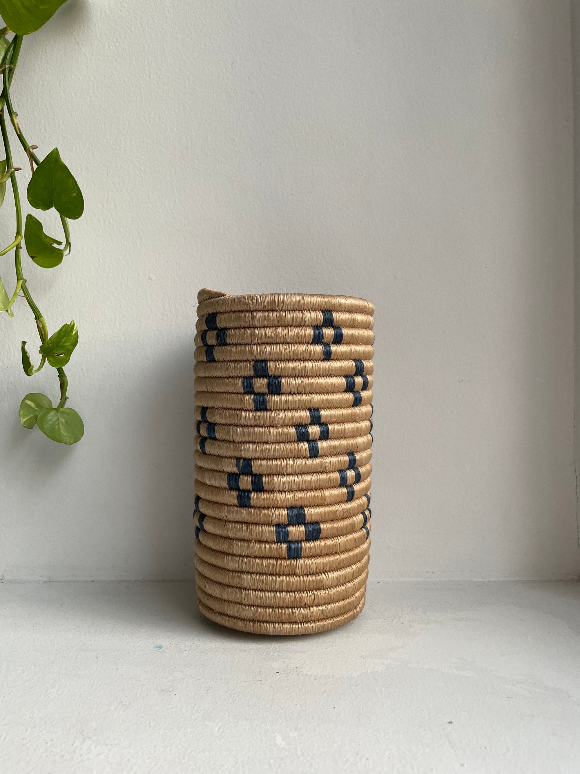 Display of beige and navy blue colored vase with floral design