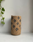 Display of beige and navy blue colored vase with floral design