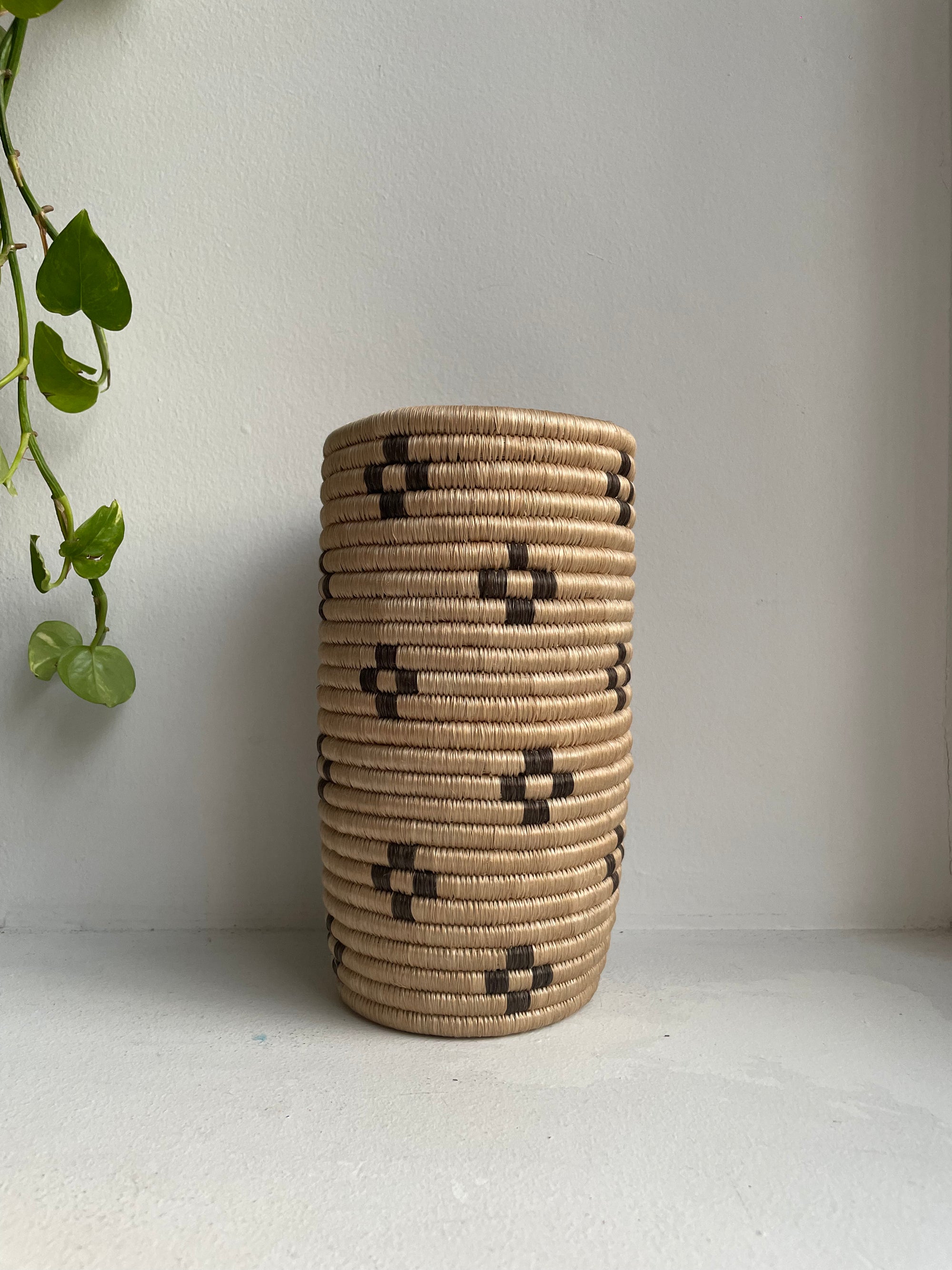 Display of beige and brown colored vase with floral design