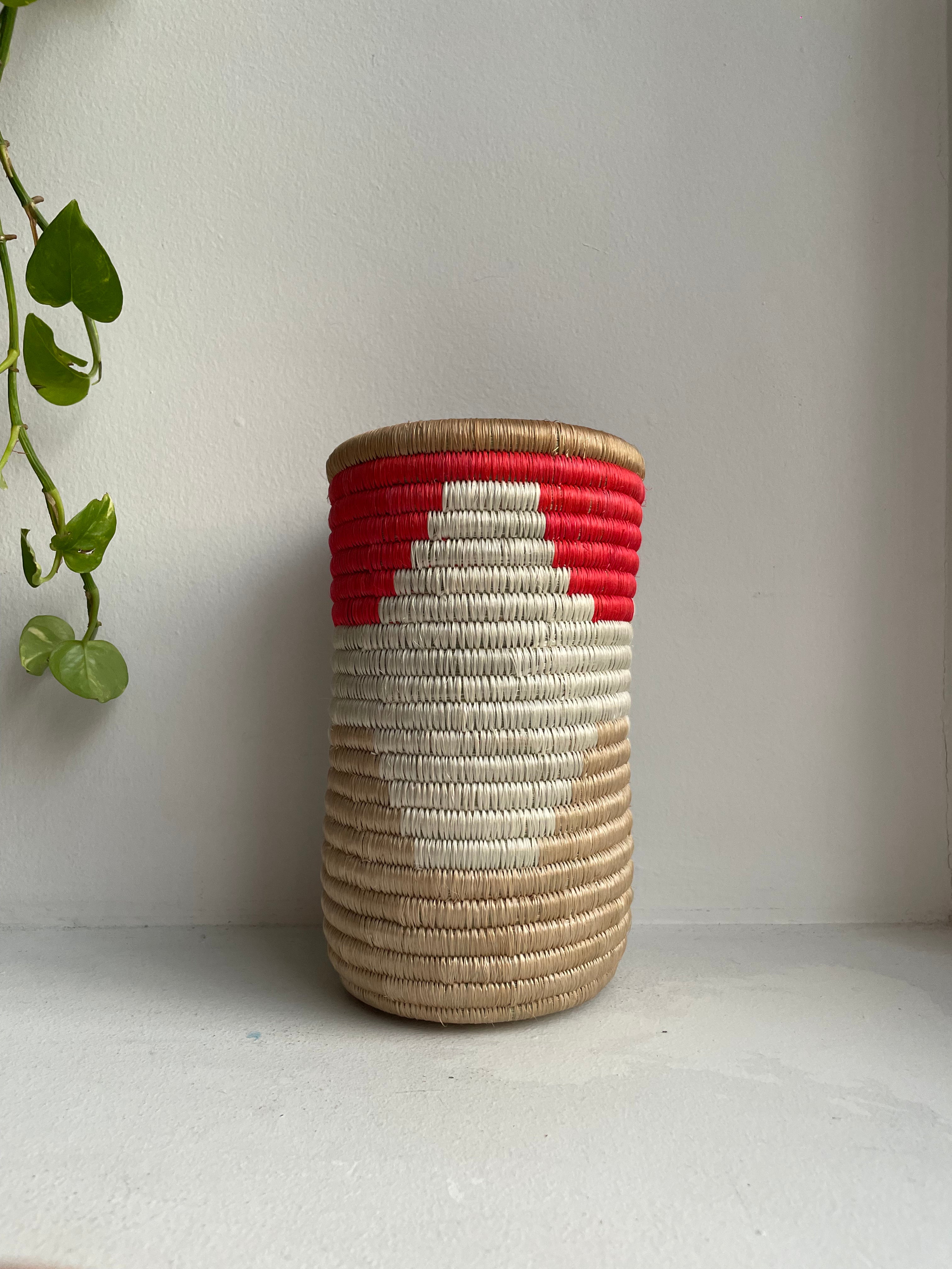 Display of red, white and beige colored vase