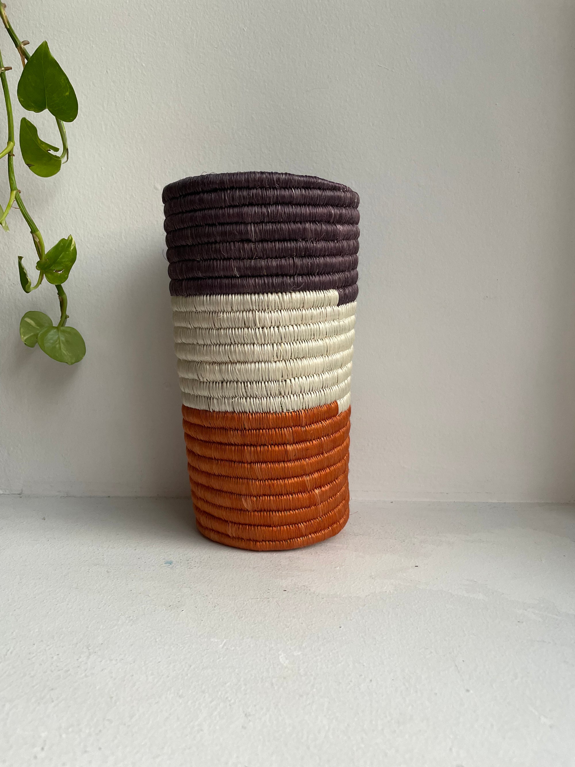 Display of orange, white and dark brown colored vase