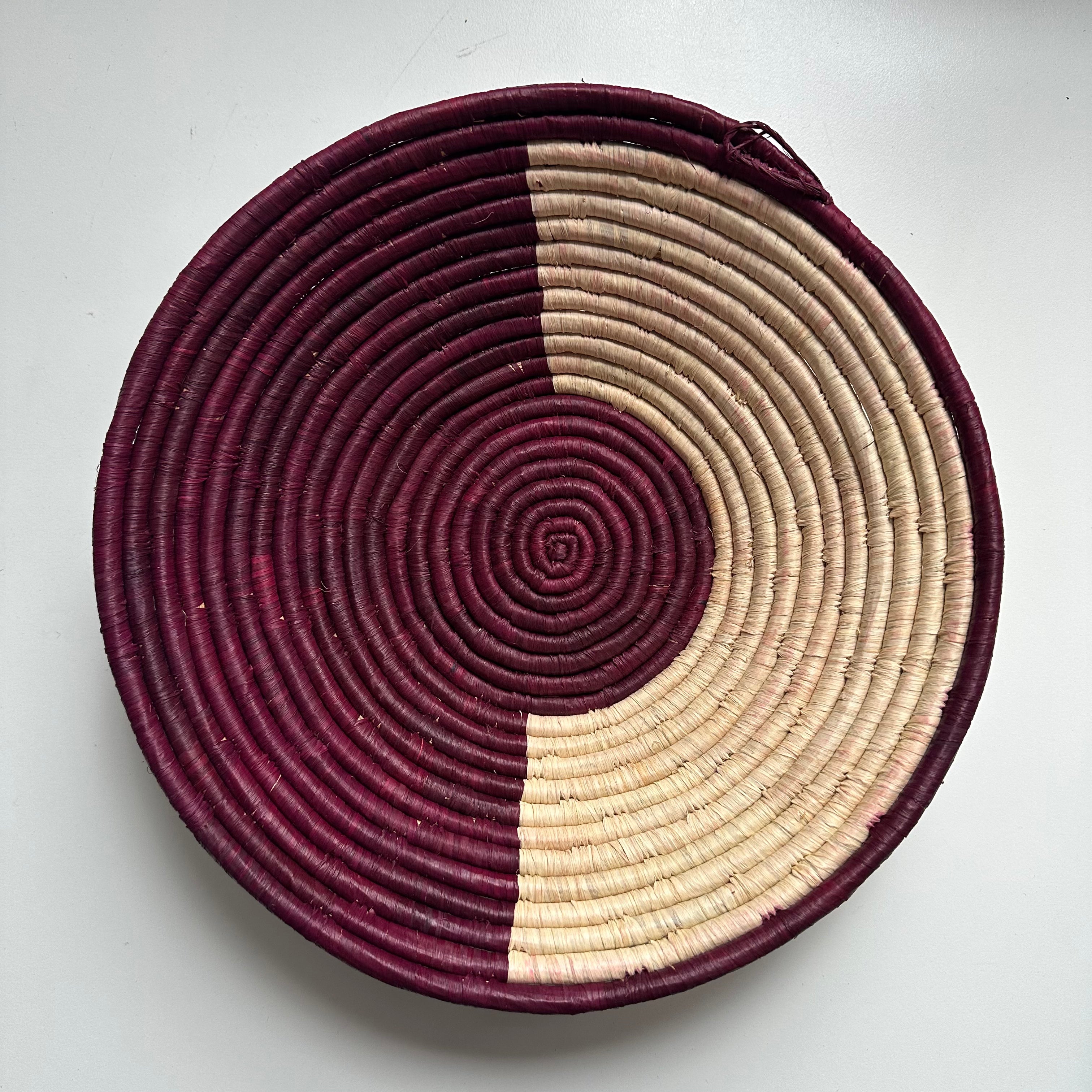 The display of burgundy and natural color handwoven bowl