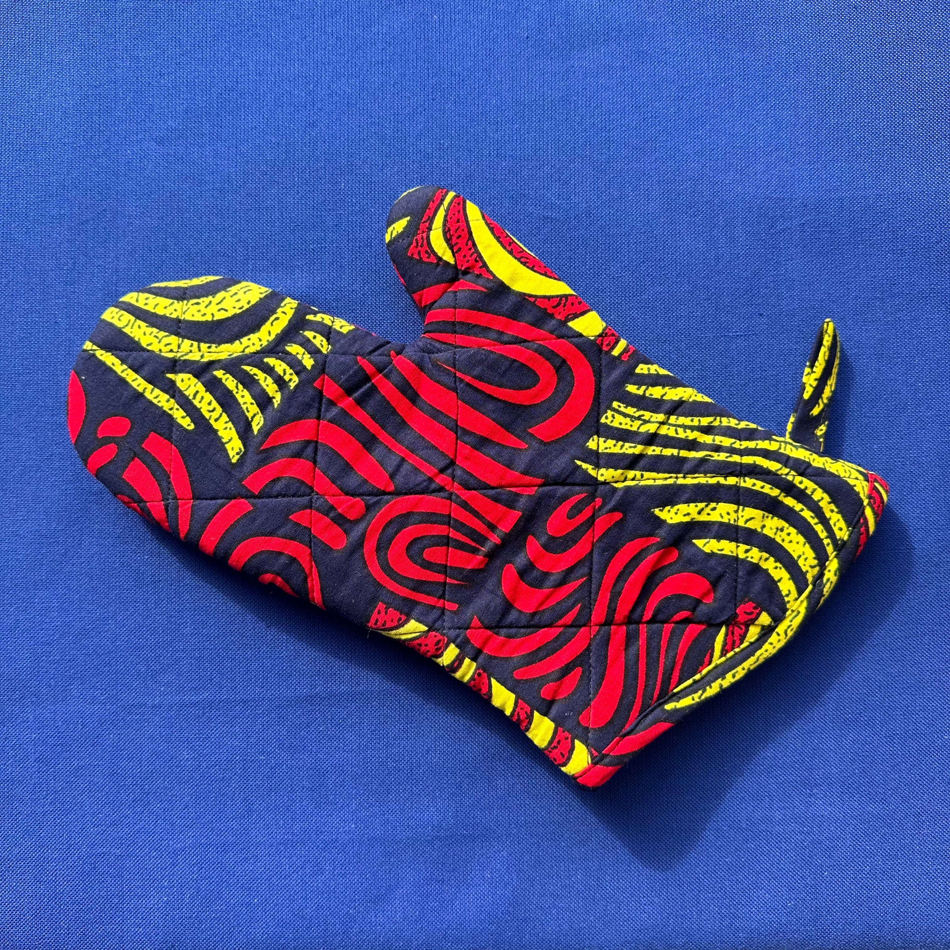Display of yellow, red and black oven mitt 