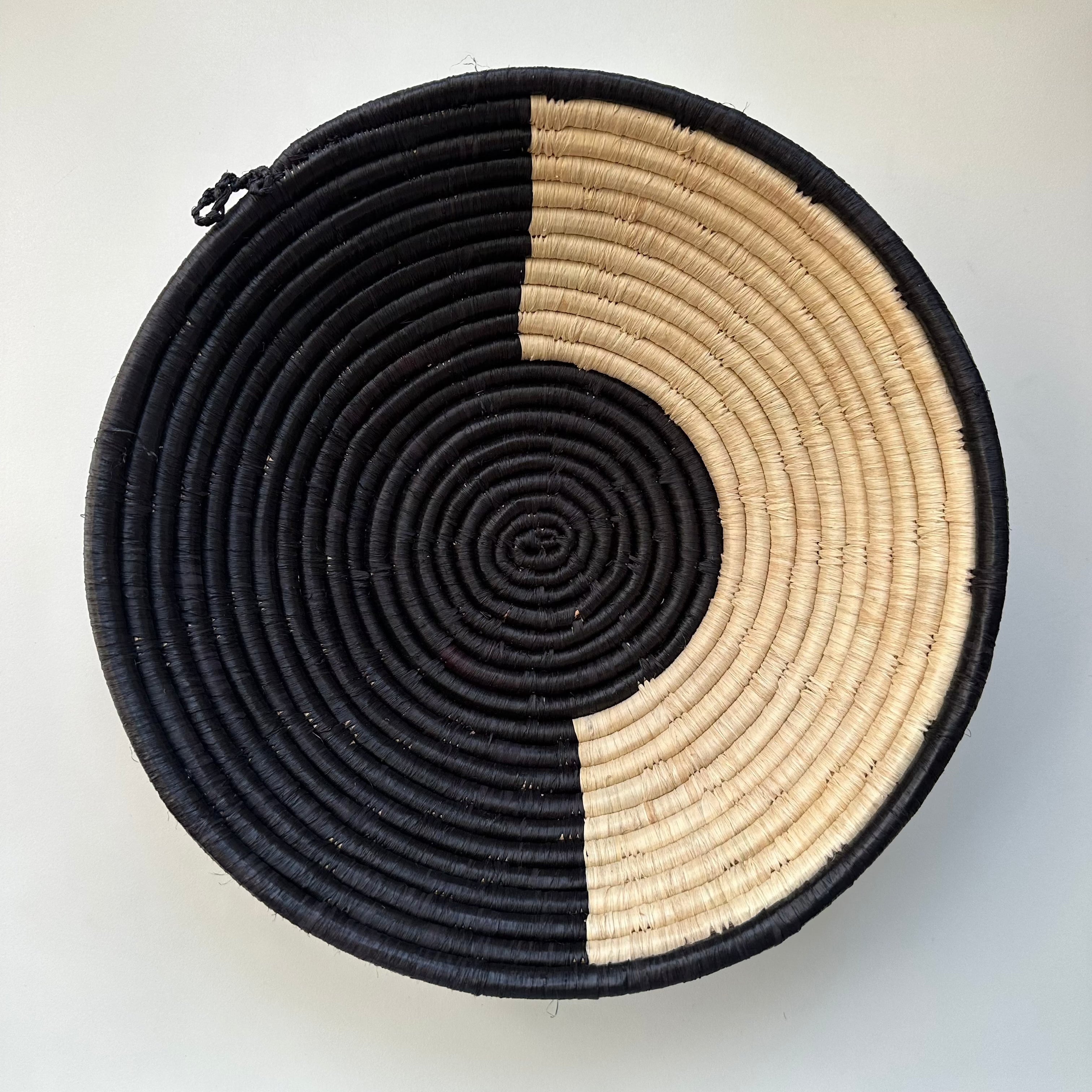 The display of black and natural color handwoven bowl