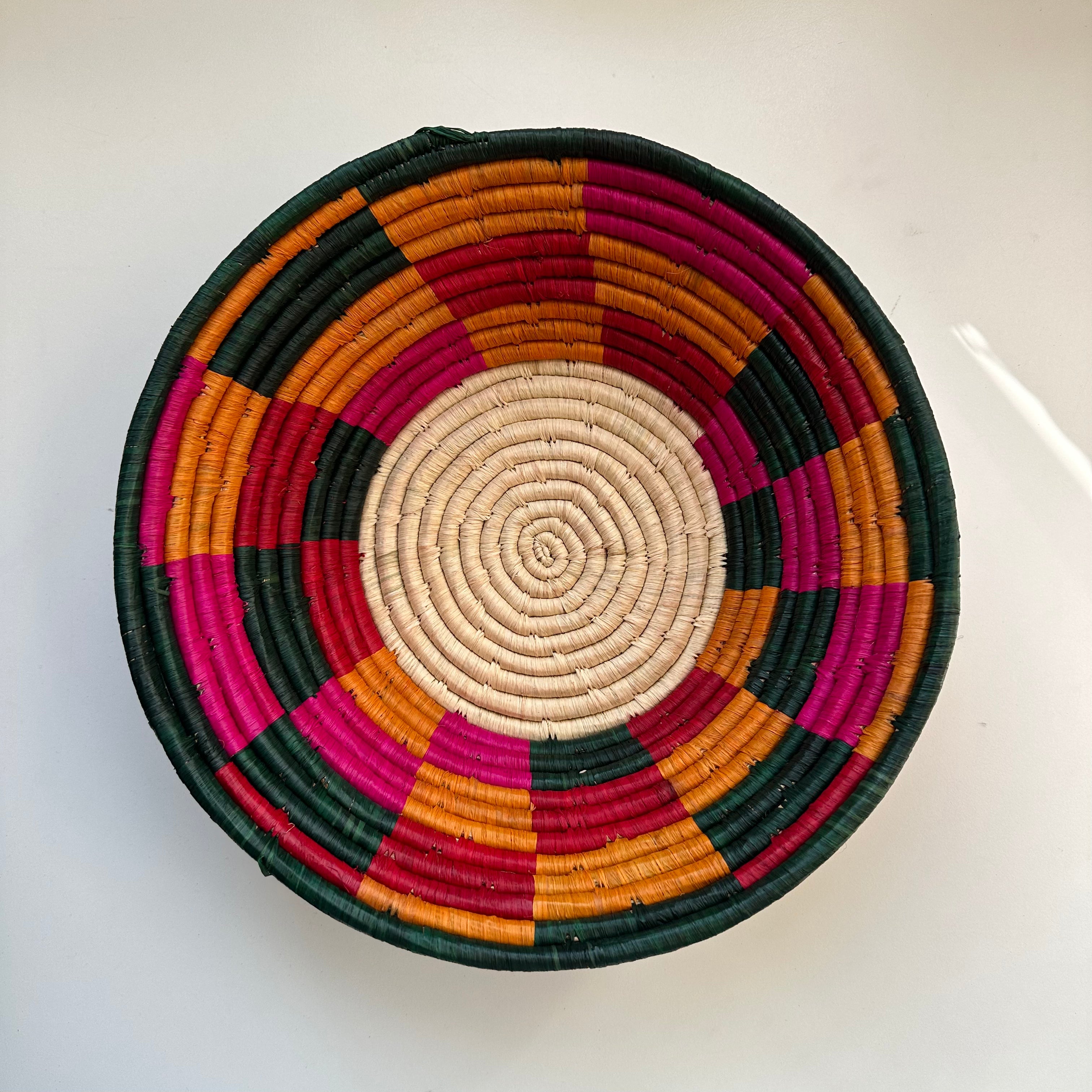 The display of pink, red, green, orange and natural color handwoven bowl
