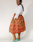 Model wearing multicolored dot print skirt.