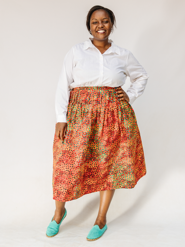 Model wearing multicolored dot print skirt.