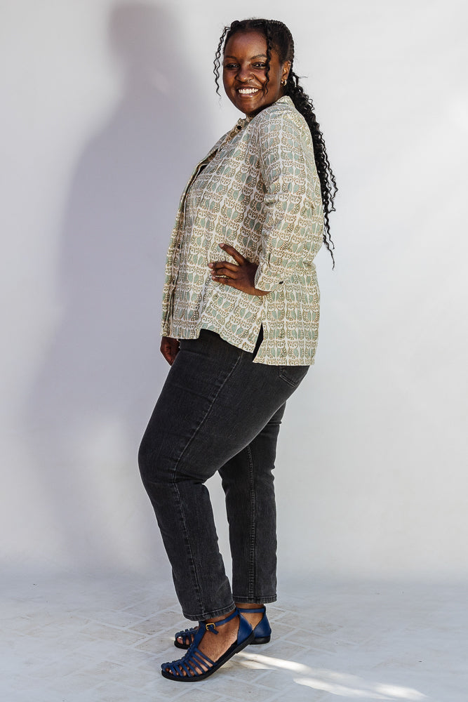 Model wearing long sleeved shirt with small owl print.