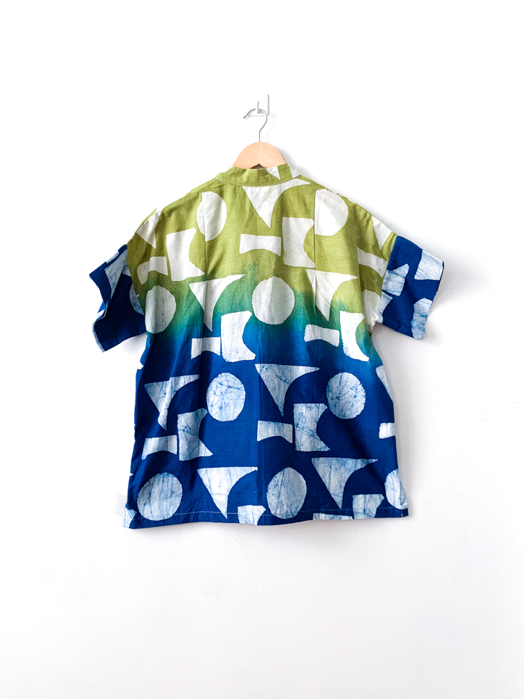 Display of yellow, green and blue geometric print batik shirt.