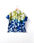 Display of yellow, green and blue geometric print batik shirt.