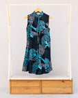 Display of sleeveless dress with blue tree print.
