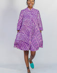 Model wearing purple and pink plaid batik dress.