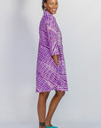 Model wearing purple and pink plaid batik dress.