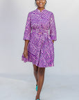 Model wearing purple and pink plaid batik dress.