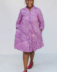 Model wearing purple and pink plaid batik dress.