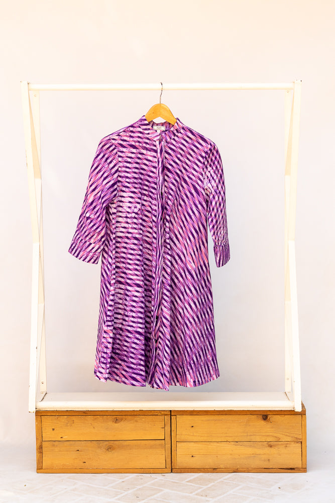 Display of purple and pink plaid batik dress.