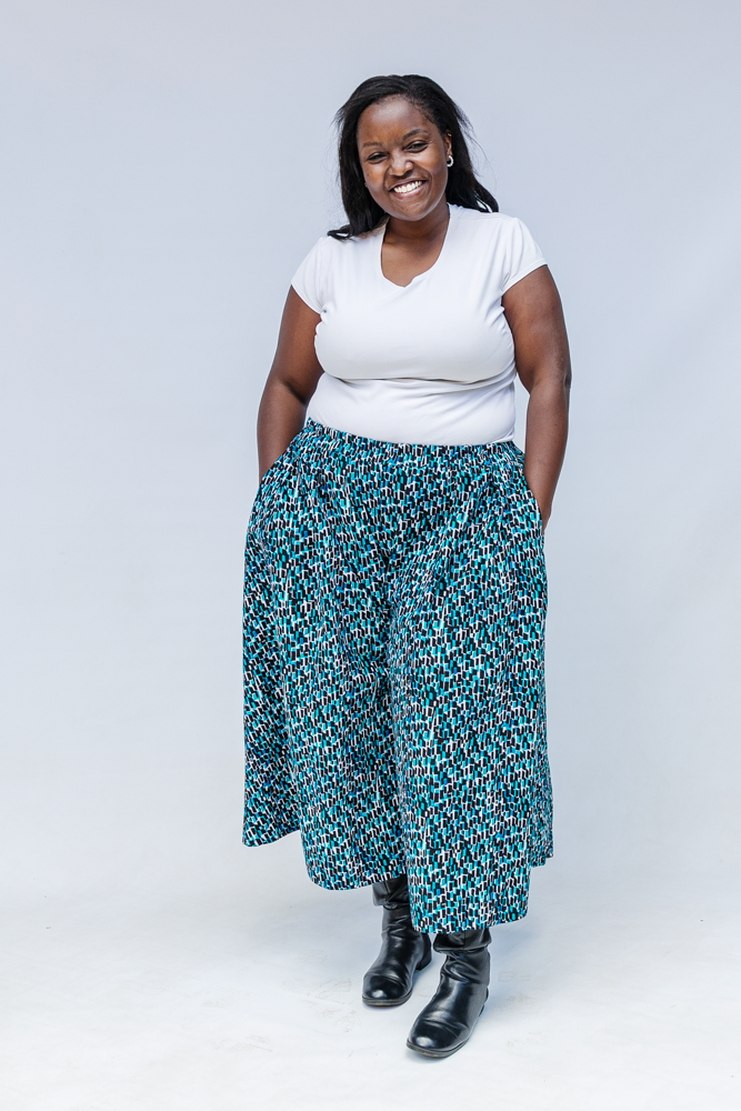 Model wearing aqua, black and white culottes.