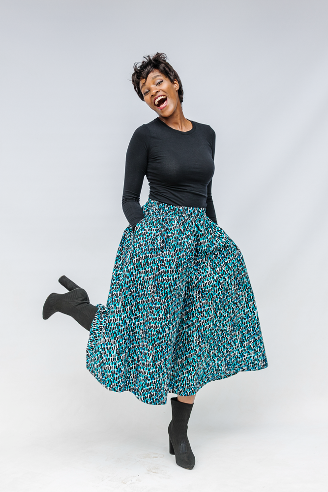 Model wearing aqua, black and white culottes.