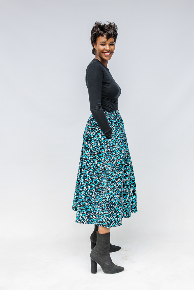 Model wearing aqua, black and white culottes.