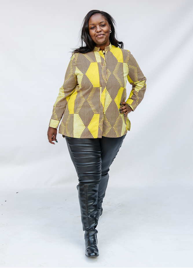 Model wearing yellow, brown and white abstract print shirt.