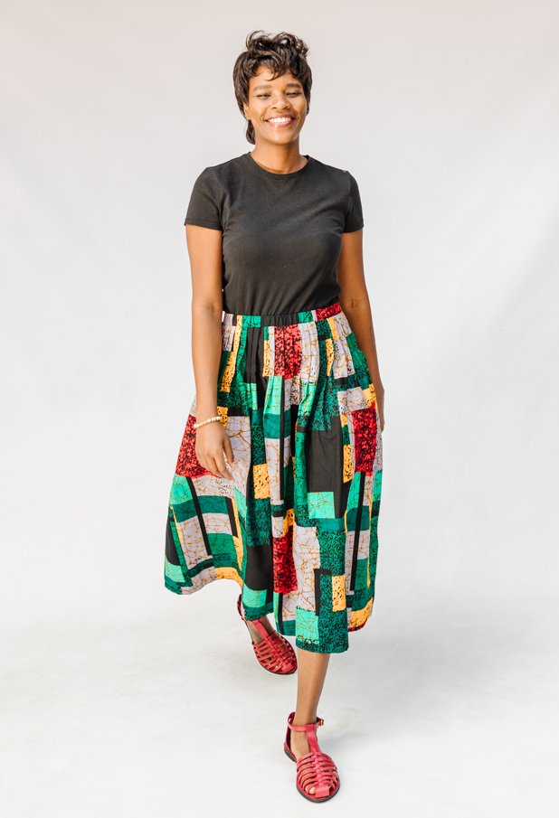 Model wearing multicolored geometric print skirt.
