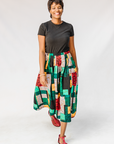 Model wearing multicolored geometric print skirt.