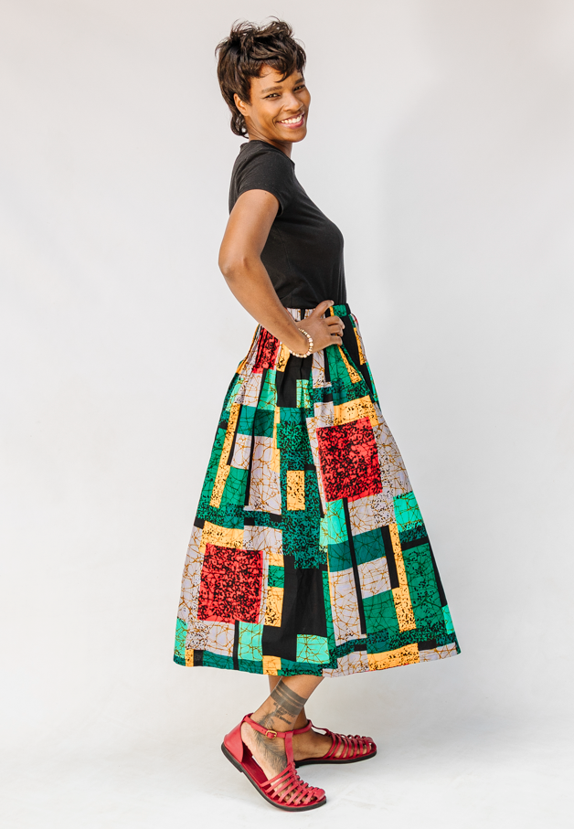 Model wearing multicolored geometric print skirt.