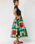 Model wearing multicolored geometric print skirt.