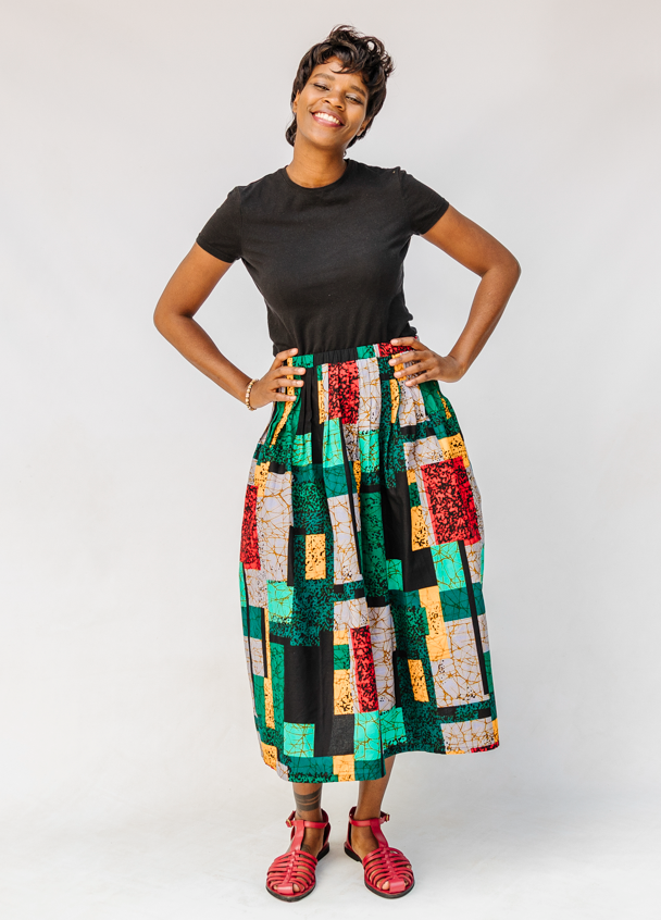 Model wearing multicolored geometric print skirt.