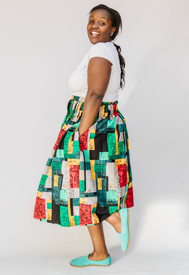 Model wearing multicolored geometric print skirt.