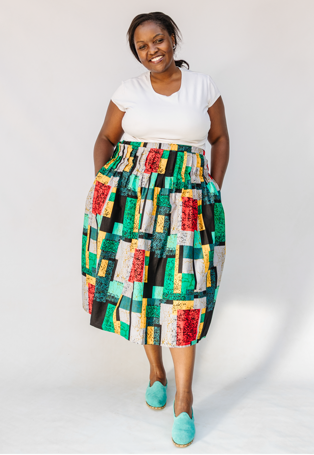 Model wearing multicolored geometric print skirt.
