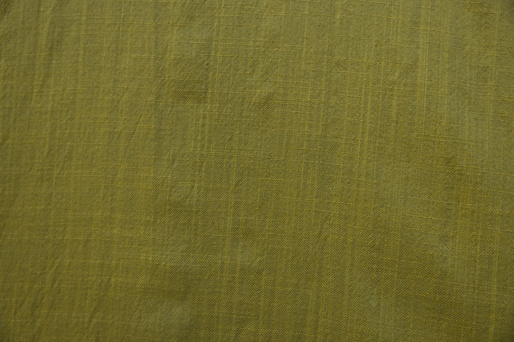 Close up display of olive green linen dress, fabric.