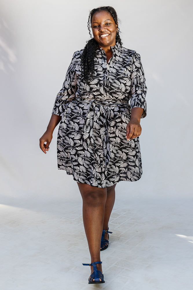 Model wearing black and white leaf print dress.
