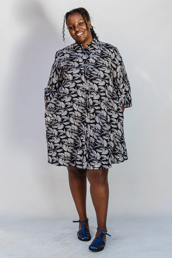 Model wearing black and white leaf print dress.