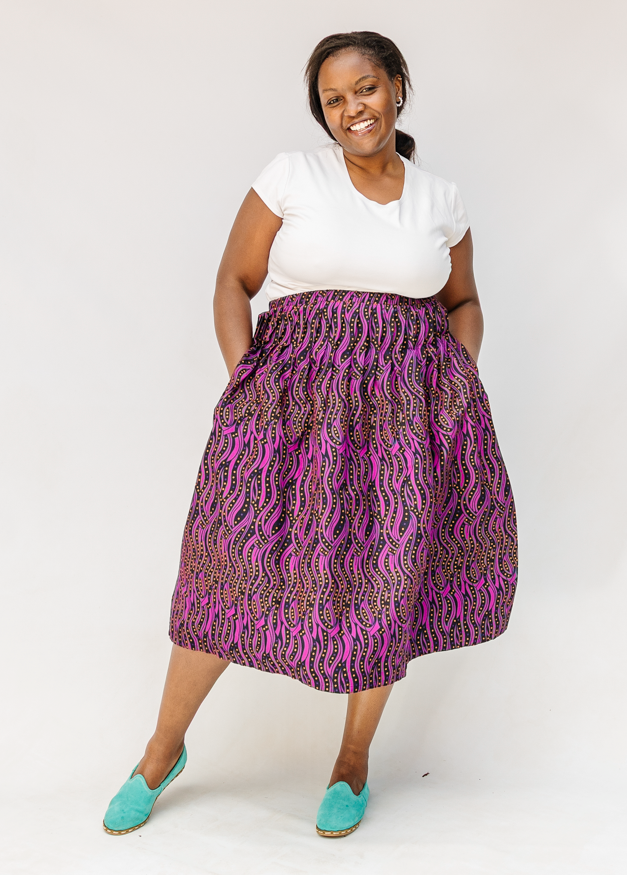 Model wearing fuchsia skirt with small dot design.