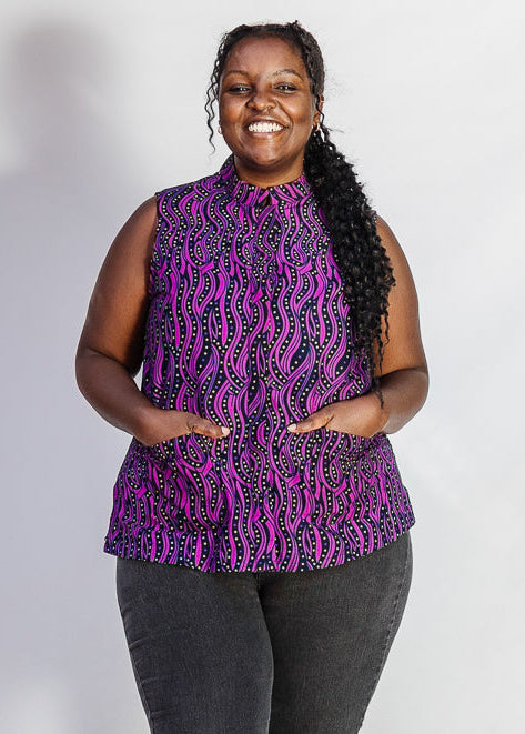 Model wearing purple and black abstract print sleeveless shirt.